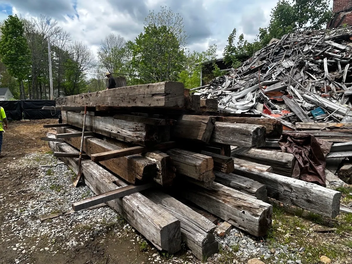 Weathered reclaimed beams stacked in a salvaged lumber yard