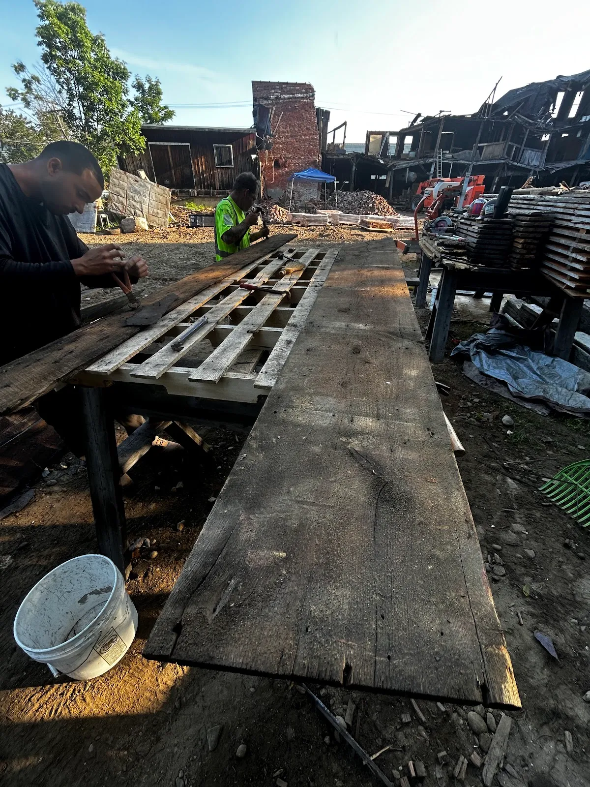 Wide reclaimed brown board resting outdoors in the lumber yard