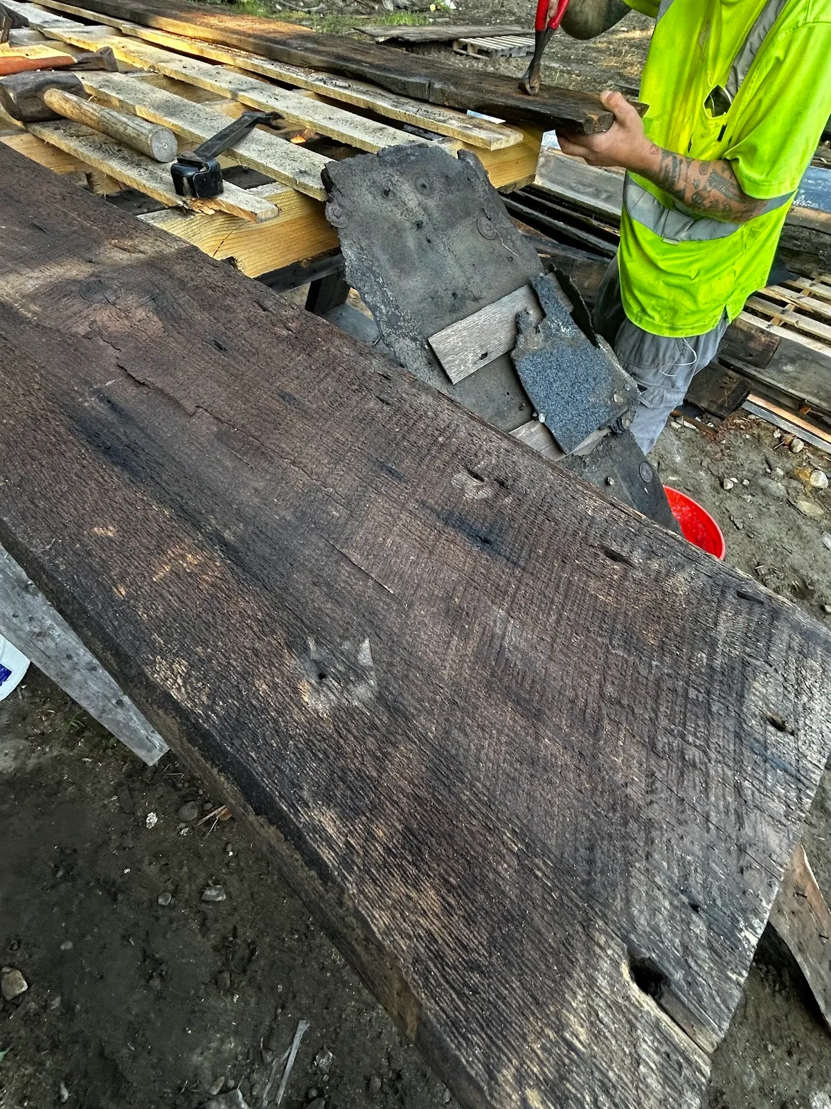 Reclaimed brown board being handled in the salvage yard