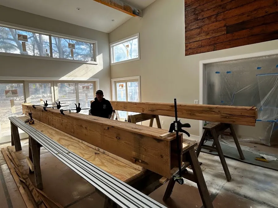 Finished heart pine box beams assembled in a bright room