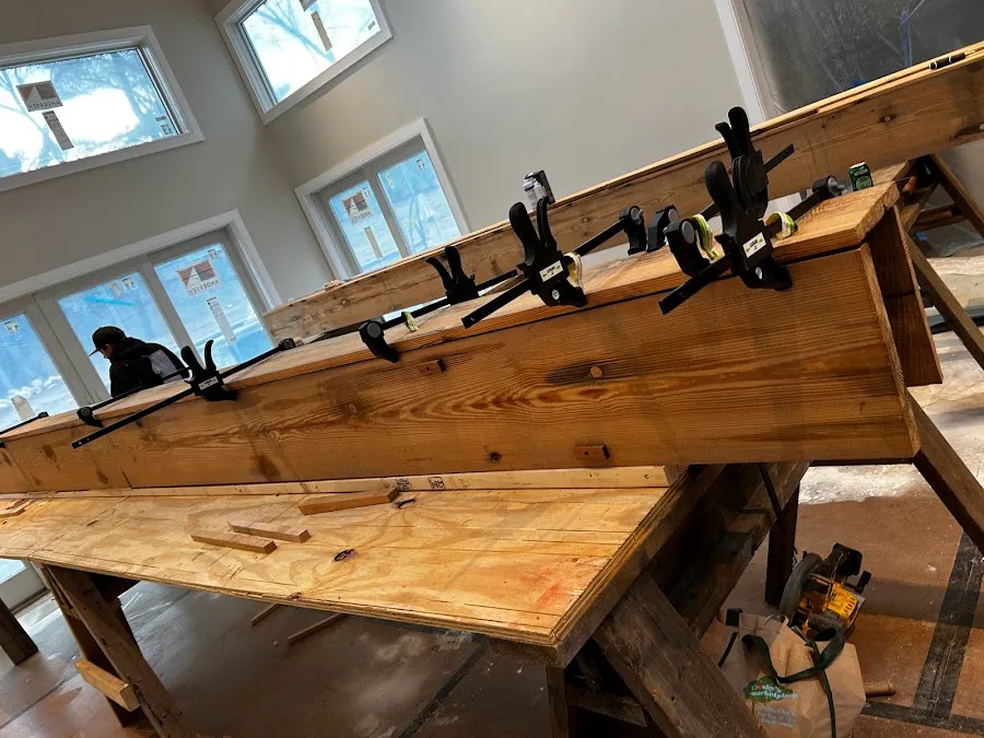 Long finished heart pine box beams resting across supports