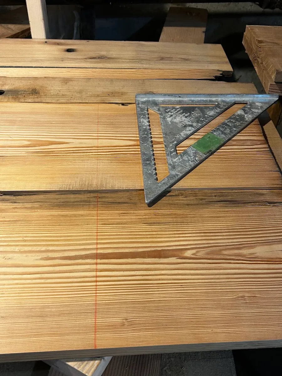 Heart pine boards marked with a square and a red layout line