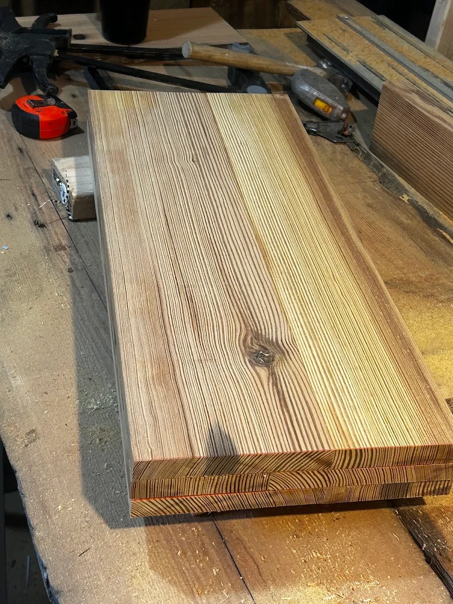 Close view of the finished heart pine table top and its breadboard end