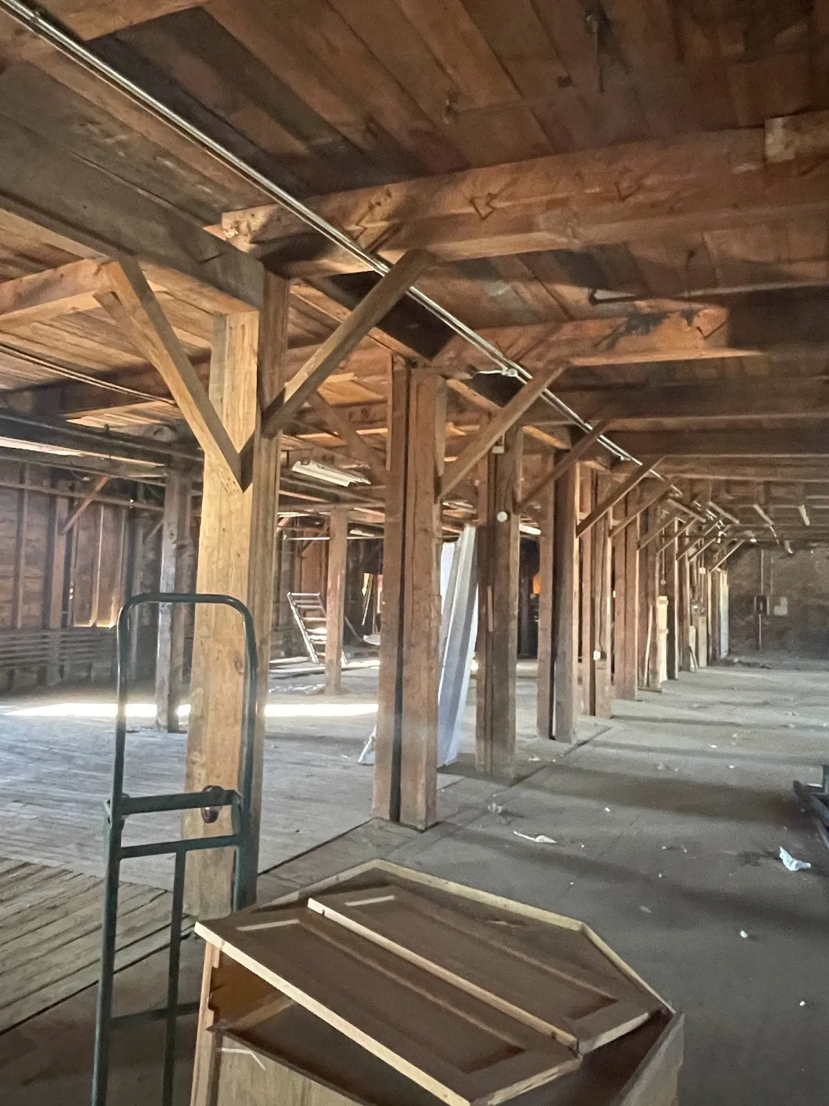Interior of the historic toy factory with rows of wood posts and beams