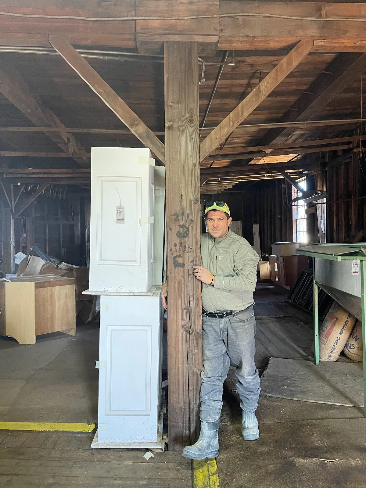 Person standing among saved materials inside the toy factory