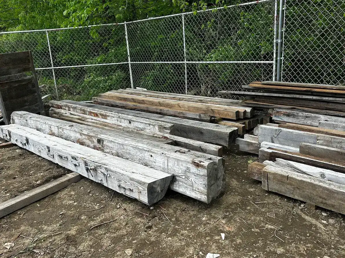 Sorted reclaimed beams laid out on the ground