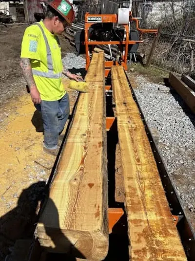 Reclaimed beam being milled into custom-made flooring